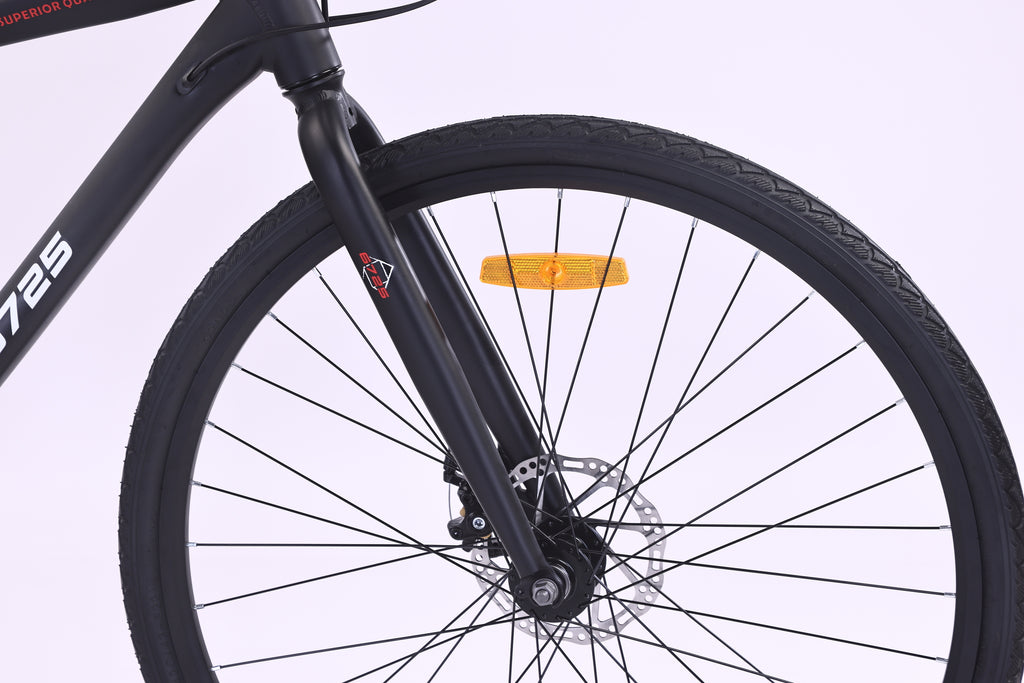 Close-up of the front wheel and fork of the 6725 Axis 700c Commuter Bike, highlighting the sleek design and braking system.