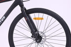 Close-up of the front wheel and fork of the 6725 Axis 700c Commuter Bike, highlighting the sleek design and braking system.